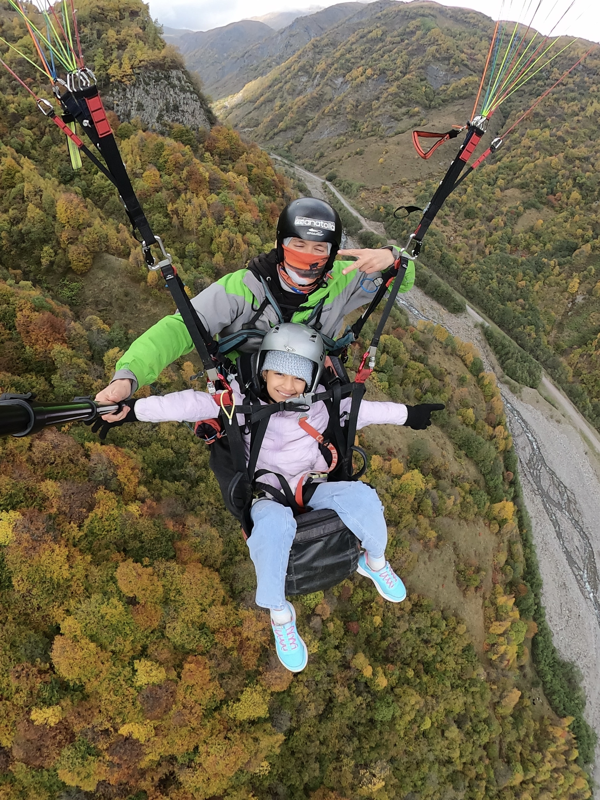 Paraglider above the Ceraunian mountain ridges with sea horizon behind