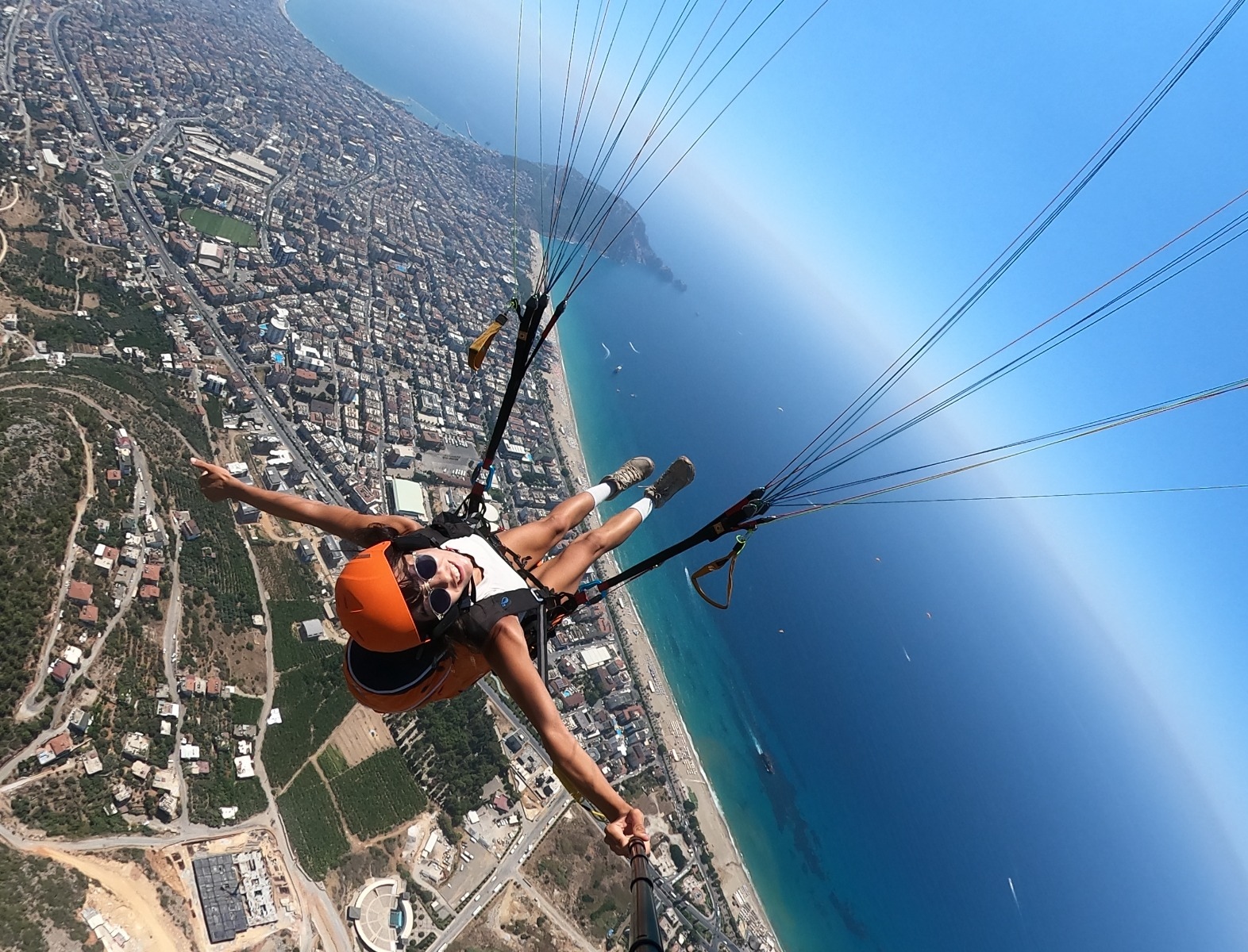 Paragliding above the Vlora shoreline with a wide view of the sea and city coast